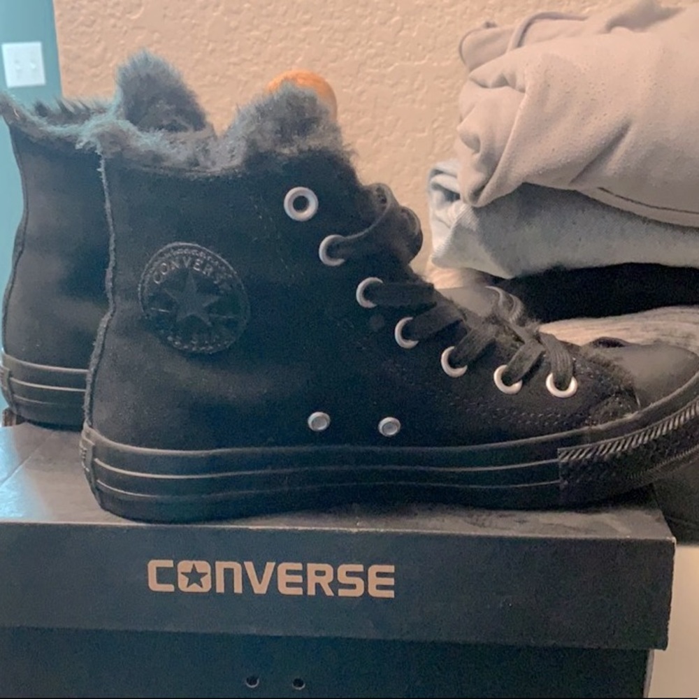 Fur lined high top suede converse.